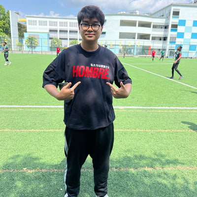 Model wearing red oversized Hombre Basics tee, Singapore streetwear brand