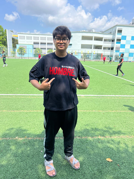 Model wearing red oversized Hombre Basics tee, Singapore streetwear brand