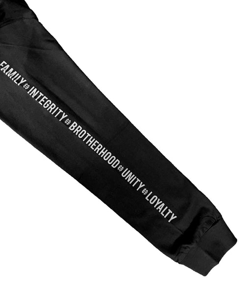 Close-up of felt emblem logo on grey long sleeve top