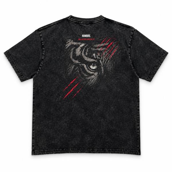 Back of HOMBRE x Balestier Khalsa FC Tiger Instinct washed black tee with large tiger-eye artwork and red claw marks