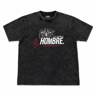 Front of HOMBRE x Balestier Khalsa FC Tiger Instinct washed black tee with tiger graphic, white HOMBRE wordmark and red claw marks